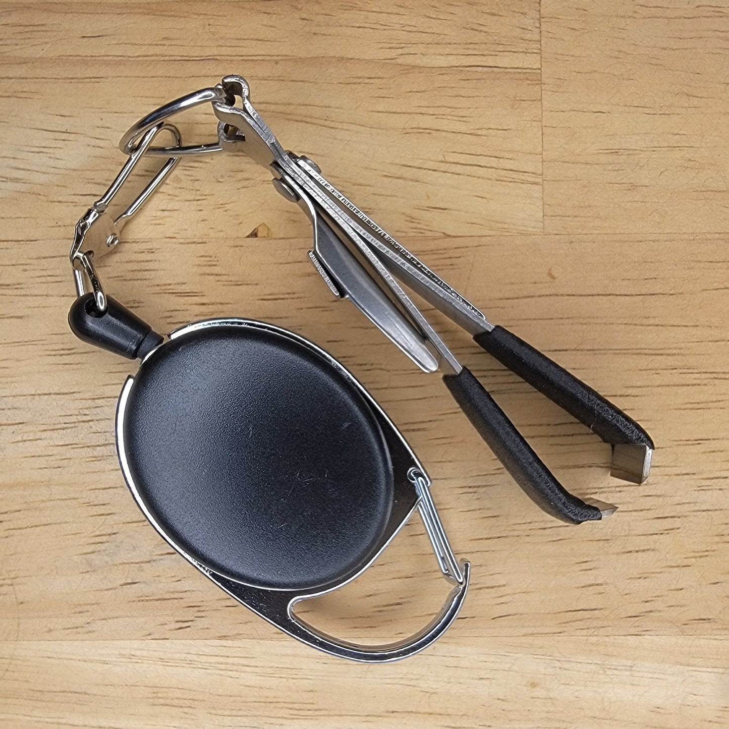 Small Tool Retractor with line clipper, eye opener, knot tyer, and hook file