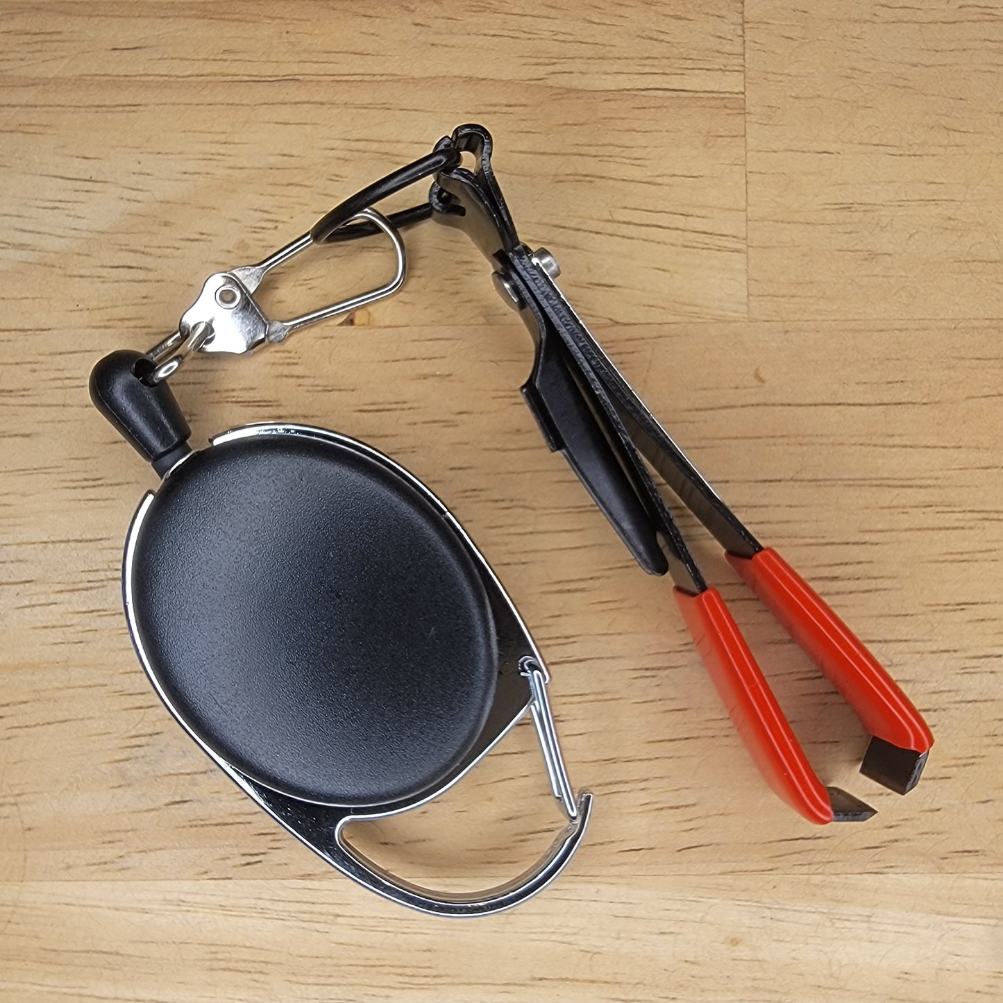 Small Tool Retractor with line clipper, eye opener, knot tyer, and hook file